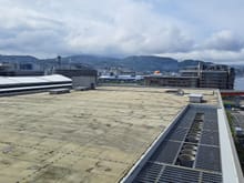 Couple of days later, it was raining when I woke up but was clearing rappidly. View of the roof of Dejima messe, the JR Station and part of the Marriott hotel on the left. The rear of a cruise ship docking can just be seen.