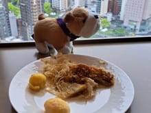 Monty ( The Conrad St James's bulldog) with a small plate of okonomiyaki in the executive lounge . I had had a full breakfast in Mozaik downstairs but Mozaik did not have oknomiyaki as far as i could tell.
