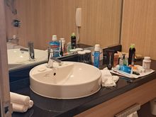 Vanity area in bathroom. Older style bathroom ( ie bath/shower combo with curtain) and wc beside the sink. Bathroom did steam up after a shower but mirror remained clear  for about half the area. Colour of lighting could be changed