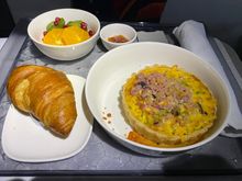 MSP-SEA Breakfast. Quiche with crumbled ham on top.  Very tasty. Other choices were cold overnight oats or hot oatmeal (weird to have two oatmeal dishes)