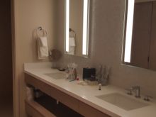 Toilet is in room at the end of the counter