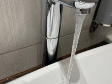 When washing your hands the water ends up splashing behind the sink