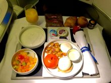 AF655 DXB-CDG, breakfast, poached eggs with spinach, potatoes and tomato, yoghurt, fresh fruit salad, müsli and pastries with condiments.