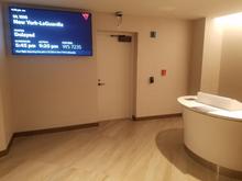 My first visit to this SC.  Apparently there are exits to gates from within the club.  I saw 3 of these.  This display showed a delayed flight, delayed past the closing time of the SC that day.