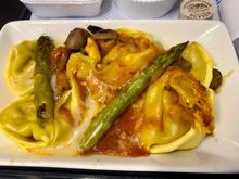 Leek and mushroom tortellini, grilled asparagus, Sicilian vegetable sauce and Grana Padano cheese
