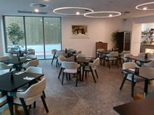 Dining area: kitchen on right; outdoor area on left can be set up for dining (maybe conferences).