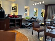 A small lounge with only 7 tables and 2 sofa's