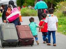 Asylum seekers walk along Roxham Road near Champlain, New York on Aug. 6, 2017, making their way towards the Canada-U.S. border. (Geoff Robins/AFP/Getty Images)