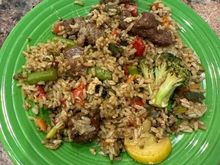 Leftover beef with broccoli, brown rice and vegetable fried rice from Pei Wei, stir fried with Costco fire roasted vegetables, soy and some red pepper flakes. 