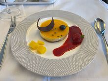 Passion fruit and hazelnut tart, dark chocolate shard, fresh berries, mangoes (again!), raspberry coulis. This was delicious.