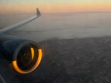 sunrise illuminating the Olympics after breaking thru the fog on climbout