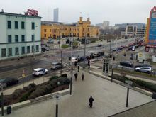 View from the hotel onto the busy street below with the railway station in the background 