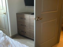 When bedroom door is open, it hits the dresser and allows only about a foot of space to walk to other side of room. 