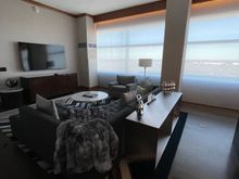 Amazingly large couch with furry throw.