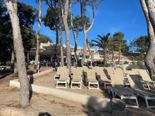 Sun chair area in front of main restaurant with its outdoor terrace