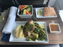 Herb roasted chicken breast with asparagus, artichoke hearts, mashed potatoes and leeks, and lemon caper sauce on side. 