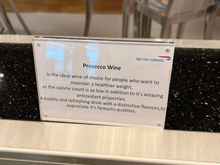 Funny sign promoting the health benefits of prosecco at BA SIN lounge