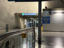 Go up the escalator and you should see long term parking. Exit through this door. It’ll be on your left when you come up from the escalator. 