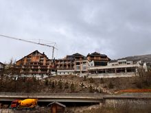 Full width shot of Aman Rosa Alpina from valley/forest/river side, as per April 18, 2025