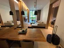 From the entryway, looking over the dining table, across the living room, and to the patio.