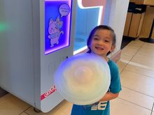 My girl with her cotton candy from the machine in the lobby 