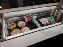 salads with or without chicken, cold cans of soda, carrots, ranch dressing, oj
