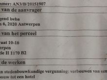Building permit says the office building is to be turned into a hotel.