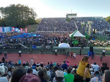 The crowd just before it started. The bleacher opposite and the one I was in filled up, as did the "pit" nearest the stage. Overflows and latecomers were on the right in this pic (obstructed view, but they set up a video screen)