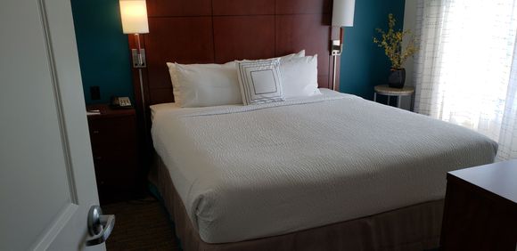 Suite bedroom with power outlets on both sides of bed 