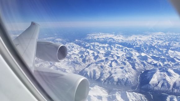 Beautiful snow-capped mountain ranges over (I believe) Mongolia