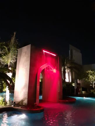 The waterfall arch at the pool at  night ( colours switch from red to green to blue to purple). Pool is closed at 7pm but nice to walk around after a work out in the gym