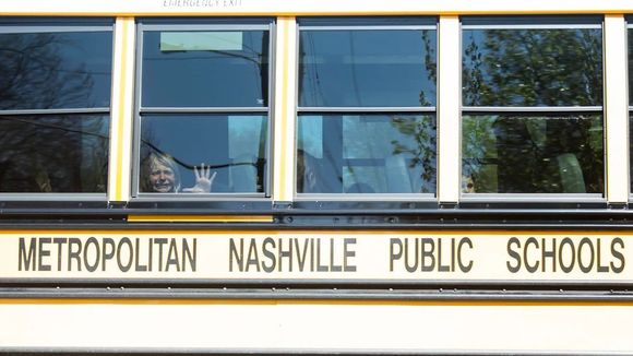 A child weeps while on the bus leaving The Covenant School following a mass shooting at the school in Nashville, Tenn., Monday, March 27, 2023. (Nicole Hester/The Tennessean via AP)
