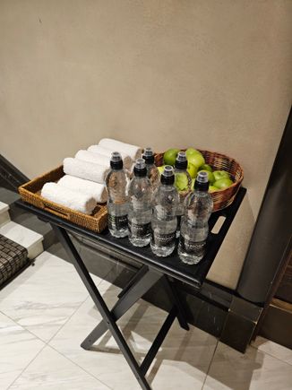Towels, water and apples at the front door in the morning