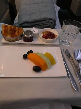 No main breakfast, just fruit, a croissant followed by a second croissant and two mugs of coffee. 
Very attentive lady as cabin crew. My nice neighbour who during conversation mentioned he travelled BA lots and was a GGL had a defective seat in J which was manually declined for him after dinner. The lady took his details so obviously lots of Avios coming his way. 

