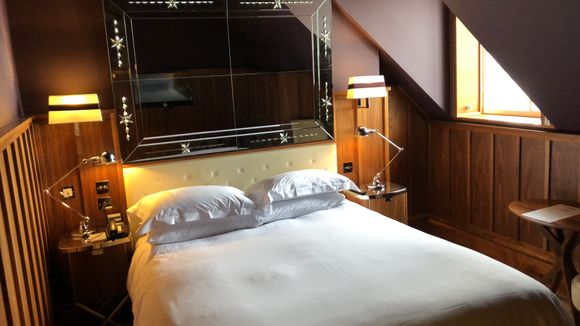 Wainscot room with one small window.