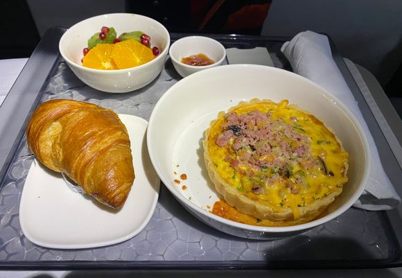 MSP-SEA Breakfast. Quiche with crumbled ham on top.  Very tasty. Other choices were cold overnight oats or hot oatmeal (weird to have two oatmeal dishes)