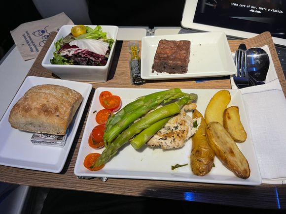 Herb Roasted Chicken with potatoes and asparagus.
Salad, Bread, and brownie served on same tray