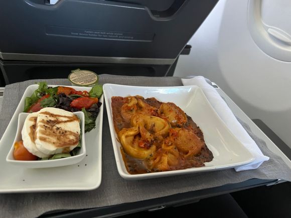 Pasta option. Standard, but probably spent a few too many minutes in the oven. The salad looked good. No bread etc. passed out as we were just below the 2,100 mile catering window. 
