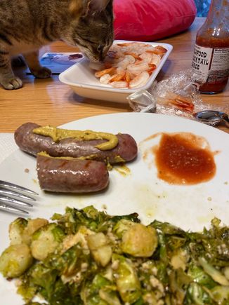 Beer brats with deli mustard, roasted Brussels sprouts with garlic, cocktail shrimp with Trader Joe’s cocktail sauce. One of the cats inspected the shrimp for quality assurance.