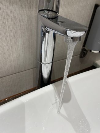 When washing your hands the water ends up splashing behind the sink