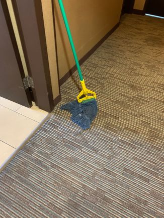 A mop in the hallway left there for over a day. 