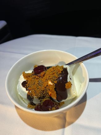 Sundae (pre assembled in galley) with fudge, cookie crumble, and tart cherries.