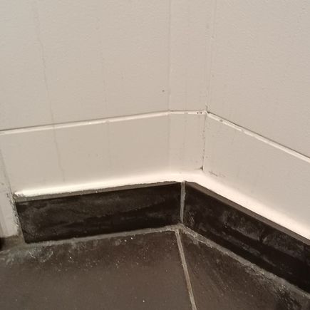 dirty tiles on the floor and wall