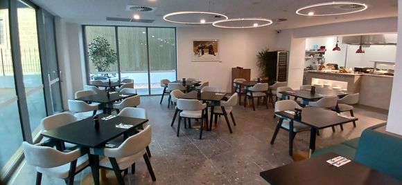 Dining area: kitchen on right; outdoor area on left can be set up for dining (maybe conferences).