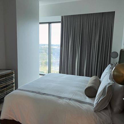 You have to walk by the bed to get to the living area