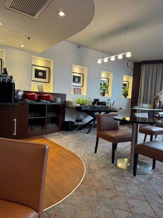 A small lounge with only 7 tables and 2 sofa's