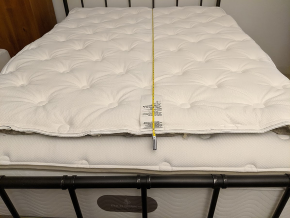 Replacement placed on top of existing topper, lined up at headboard.