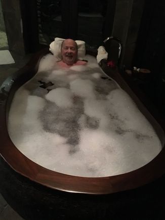 Jim bubble bath in the hand-carved indoor tub