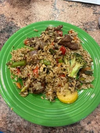Leftover beef with broccoli, brown rice and vegetable fried rice from Pei Wei, stir fried with Costco fire roasted vegetables, soy and some red pepper flakes. 