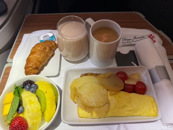 The breakfast service started about 1h45m for landing.  The omelet was decent, the fruit was excellent, and the croissant was crispy and dry.